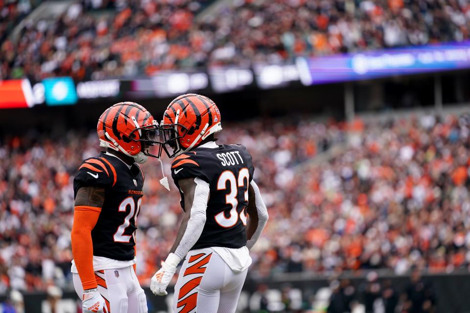 Cincinnati Bengals cornerback Cam Taylor-Britt (29), left, and Cincinnati Bengals safety Nick Scott (33), right, celebrate a defensive stop in the third quarter during an NFL football game between the Seattle Seahawks and the Cincinnati Bengals Sunday, Oct. 15, 2023, at Paycor Stadium in Cincinnati. The Cincinnati Bengals won, 17-13.