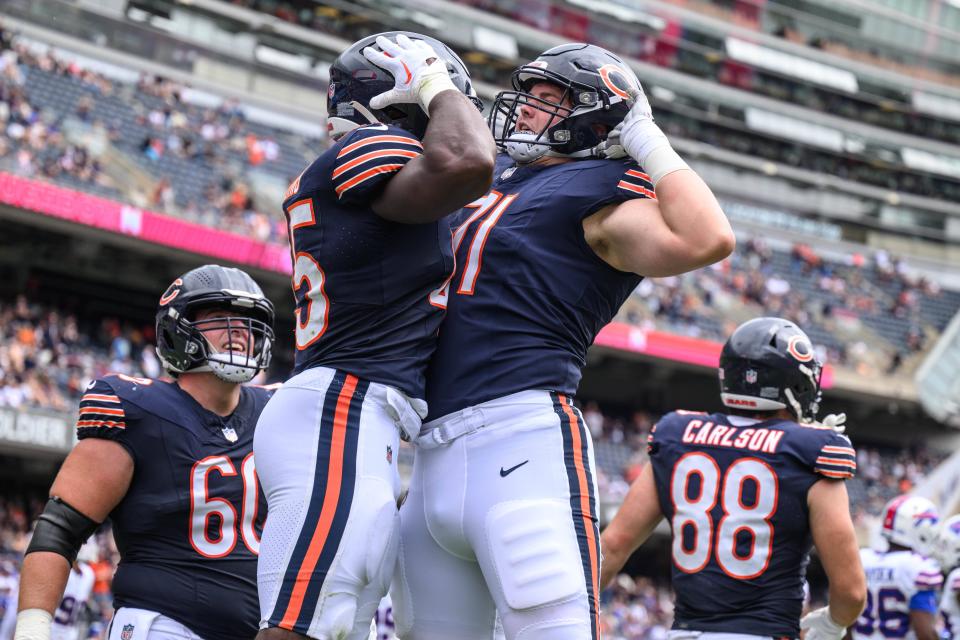 Chicago Bears running back Robert Burns (45) celebrates with offensive guard Logan Stenberg (71) after scoring a touchdown against the Buffalo Bills during the fourth quarter at Soldier Field.