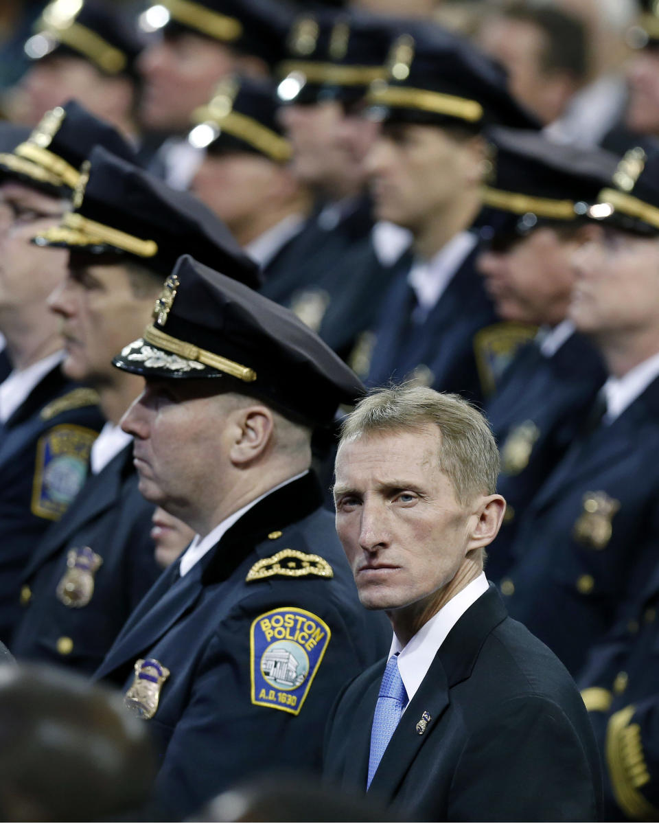 FILE - In this Jan. 6, 2014 file photo, acting Boston Police Commissioner William Evans, foreground, attends the inauguration ceremony for Mayor Martin Walsh in Boston. Evans has run the Boston Marathon 18 times, and finished in 2013 before the bombings occurred. This time he will be there as police commissioner, supervising increased security. "It weighs heavy on my mind, that I want this to go off well," he says. "I don’t want anyone hurt. I don’t ever want a repeat of the tragedy we saw that day." (AP Photo/Michael Dwyer, File)