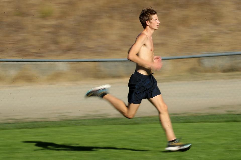 Central Kitsap junior Blake Reynolds  strides across a field during practice at the Anderson Hill Athletic Fields in Silverdale on Wednesday, Oct. 12, 2022.