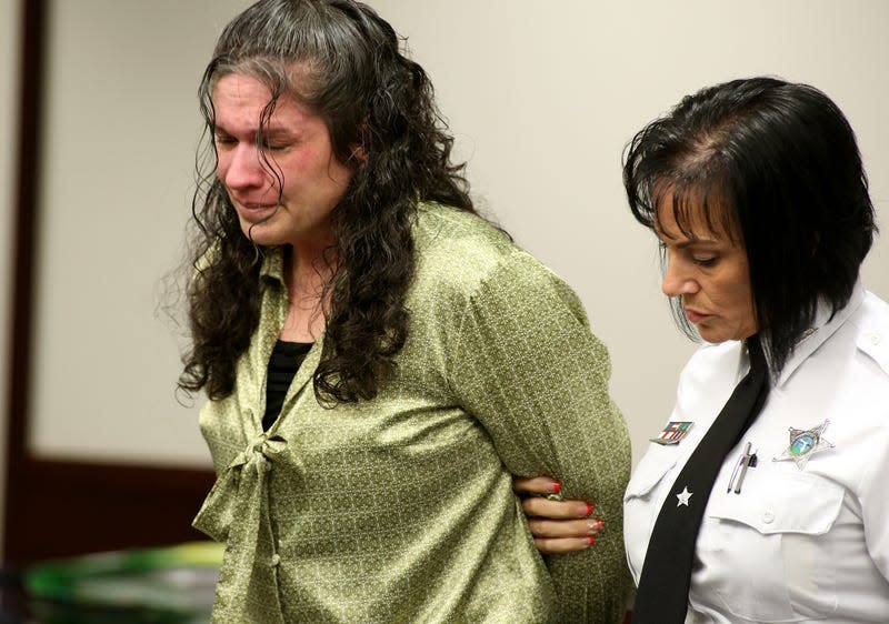 Defendant Dorice Moore, left cries as she is led out of the courtroom for a lunch break after listening to a secret audio recording made by informant Greg Smith during Moore’s murder trial on Tuesday, Dec. 4, 2012 in Tampa, Fla. Moore, 40, is charged with first-degree murder in the 2009 shooting death of Abraham Shakespeare, who won the $30 million lottery three years before he was killed.