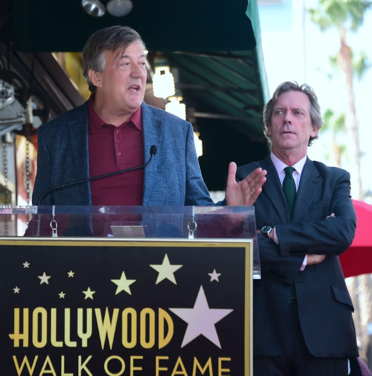 Hugh Laurie listens as Stephen Fry speaks at Laurie's Hollywood Walk of Fame star ceremony on October 25, 2016 in Hollywood, California