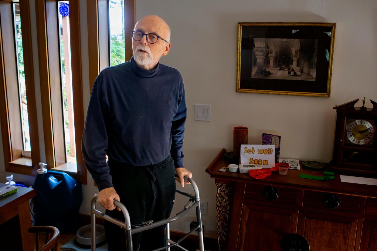 Bruce Kelsh walks with the aid of a walker in his Cottage Grove home Wednesday after falling and breaking his hip after last week's ice storm.