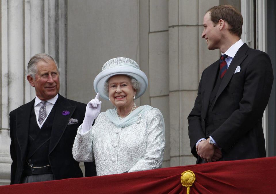 Queen Elizabeth II gesturing on the balcony of Buckingham Palace as Prince Charles and Prince William look on during the Diamond Jubilee celebrations (PA)
