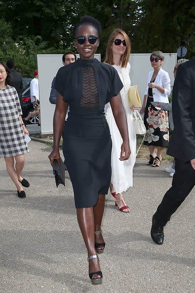 Lupita Nyong'o stuns in a fitted black sheer panel dress at Maison Margiela.