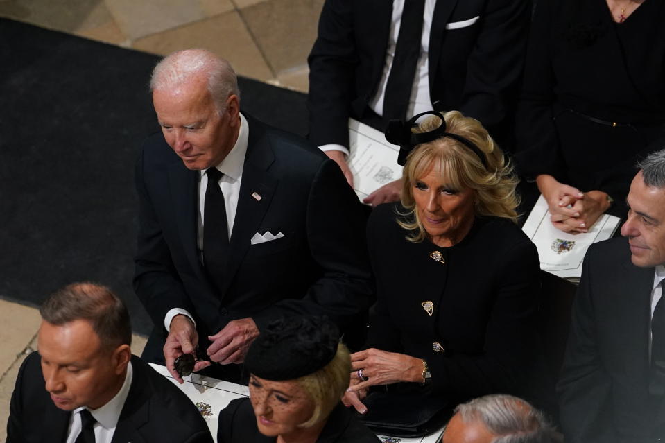 US President Joe Biden accompanied by the First Lady Jill Biden arrive for the State Funeral of Queen Elizabeth II, held at Westminster Abbey, London, Monday, Sept. 19, 2022. (Gareth Fuller/Pool Photo via AP)