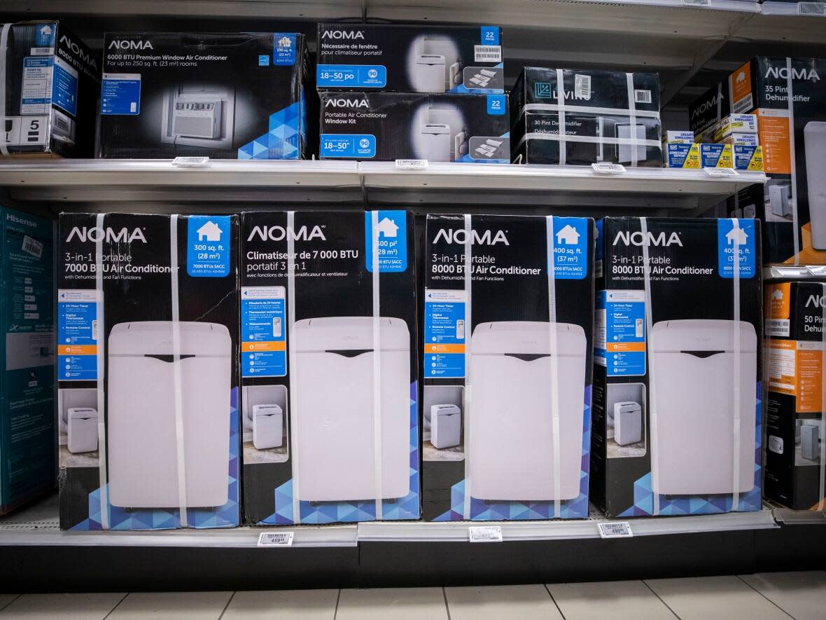 Air conditioning units for sale at a Canadian Tire store in Vancouver in June. The province should be working to give air conditioners to help vulnerable people, advocates say. (Ben Nelms/CBC - image credit)