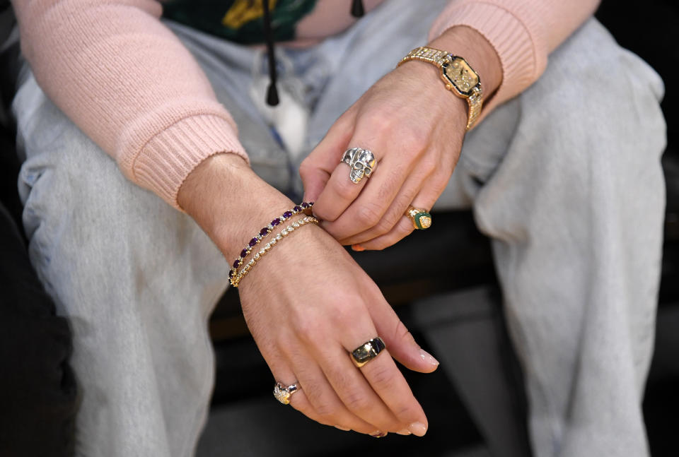 LOS ANGELES, CA - JANUARY 20: Jewelry worn by Bad Bunny as he attends the to Los Angeles Lakers and Memphis Grizzlies basketball game at Crypto.com Arena on January 20, 2023 in Los Angeles, California. NOTE TO USER: User expressly acknowledges and agrees that, by downloading and or using this photograph, User is consenting to the terms and conditions of the Getty Images License Agreement. (Photo by Kevork Djansezian/Getty Images)