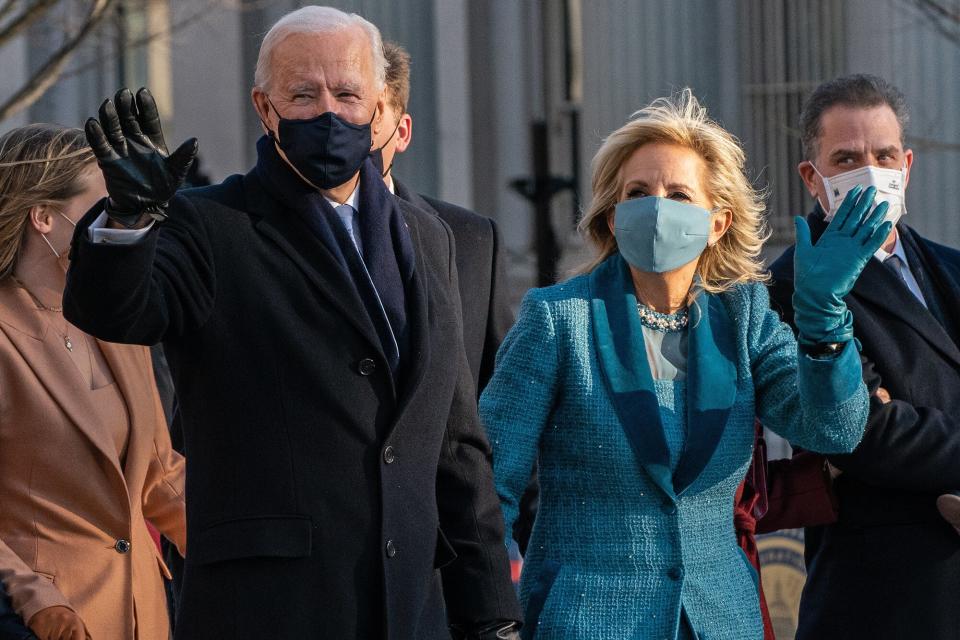 U.S. President Joe Biden and First Lady Jill Biden wave while arriving at the White House during the 59th presidential inauguration parade in Washington, D.C., U.S., on Wednesday, Jan. 20, 2021. Biden will propose a broad immigration overhaul on his first day as president, including a shortened pathway to U.S. citizenship for undocumented migrants - a complete reversal from Donald Trump's immigration restrictions and crackdowns, but one that faces major roadblocks in Congress.