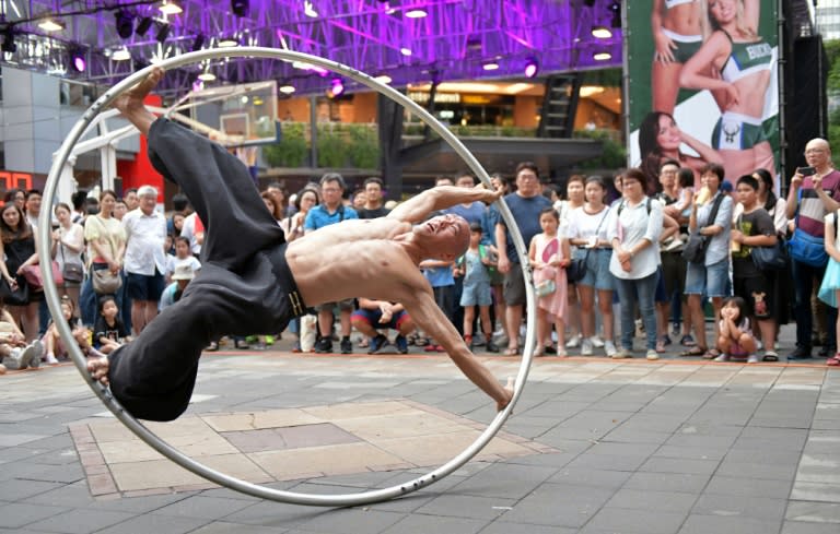 Taiwanese American street artist Isaac Hou began performing with a Cyr wheel because he wanted to move away from juggling with fire