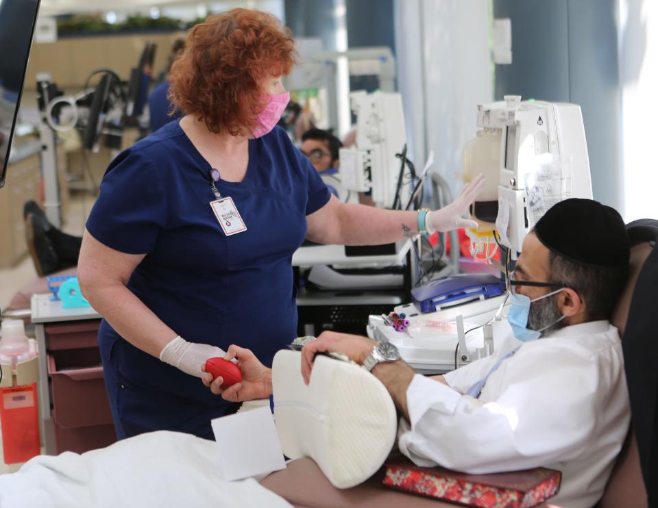 Joy DeLucia draws blood and blood plasma from Menashe Sadik of Baltimore at the Blood Bank of Delmarva in Stanton in 2020.