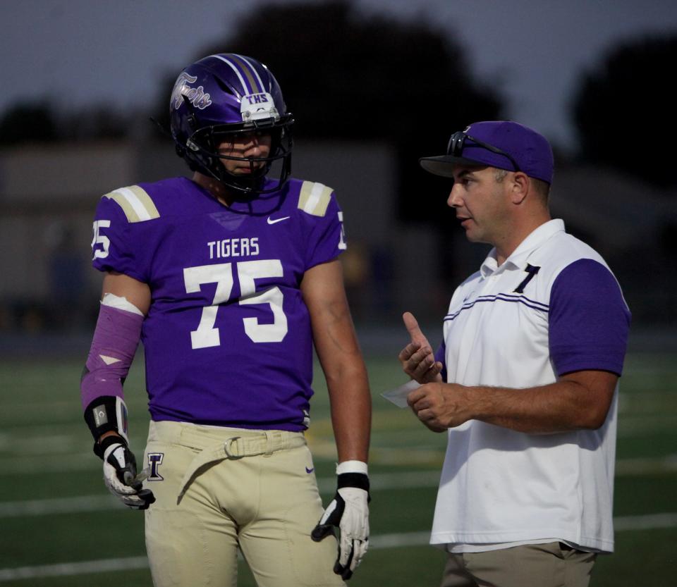 Tokay's John Dillon listens to Assistant Coach Braden Dillon before game time Friday night.