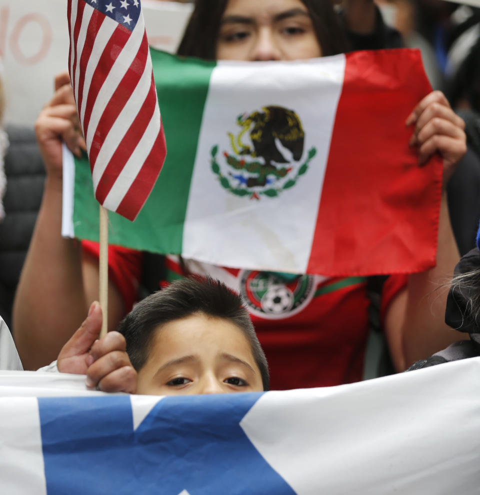 A young boy participates in a protest and march aimed squarely at President Donald Trump's efforts to crack down on immigration Thursday, Feb. 16, 2017, in Chicago. Immigrants around the country have been staying home from work and school today, hoping to demonstrate their importance to America's economy and its way of life. (AP Photo/Charles Rex Arbogast)