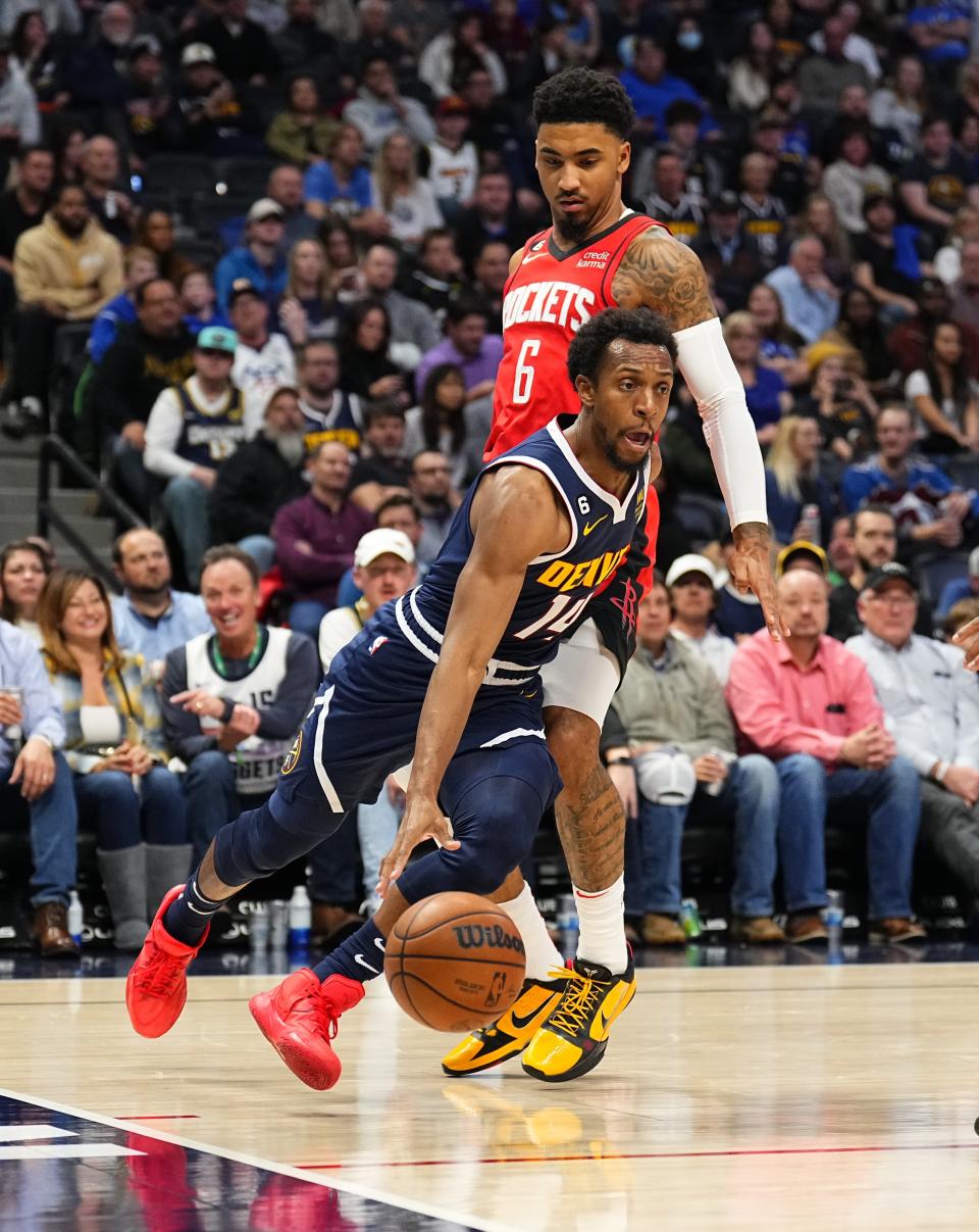 Denver Nuggets guard Ish Smith (14) drives to the basket against Houston Rockets forward Kenyon Martin Jr. (6) during the fourth quarter of an NBA basketball game, Monday, Nov. 28, 2022, in Denver. (AP Photo/Jack Dempsey)