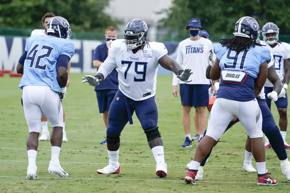 FILE - In this Friday, Aug. 28, 2020, file photo, Tennessee Titans offensive tackle Isaiah Wilson (79) runs a drill during NFL football training camp in Nashville, Tenn. A person familiar with the deal said Monday, March 8, 2021, that the Tennessee Titans have traded offensive lineman Wilson to the Miami Dolphins in a move unloading their first-round draft pick after his rookie season. (AP Photo/Mark Humphrey, Pool, File)