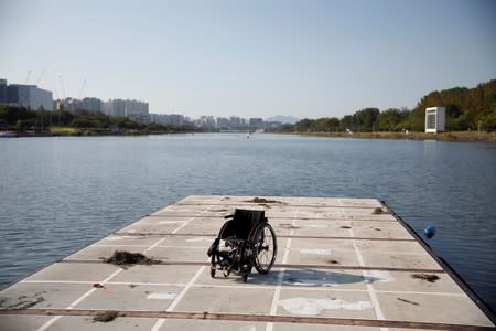 Empty wheelchair is seen as former South Korean Army sergeant, Ha Jae-hun, who lost both his legs in 2015 when he stepped on a North Korean landmine while on patrol in the DMZ, takes part in a practice session at Misari Rowing Stadium in Hanam, South Korea