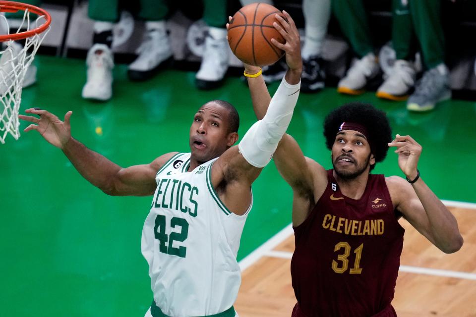Boston Celtics center Al Horford (42) grabs a rebound against Cleveland Cavaliers center Jarrett Allen (31) during the second half of an NBA basketball game Wednesday, March 1, 2023, in Boston. (AP Photo/Charles Krupa)