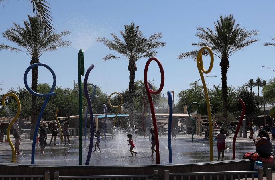 PHOTO: Kids play in a splash pad at Riverview Park on June 05, 2024 in Mesa, Ariz. (Justin Sullivan/Getty Images)