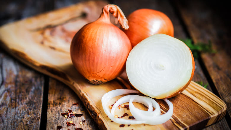 yellow onions on cutting board