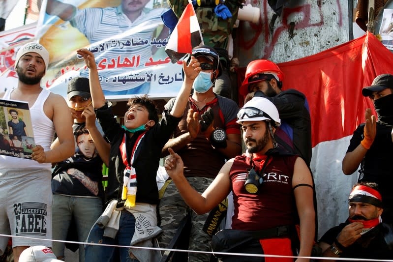 Iraqi demonstrators chant slogans during an ongoing anti-government protest