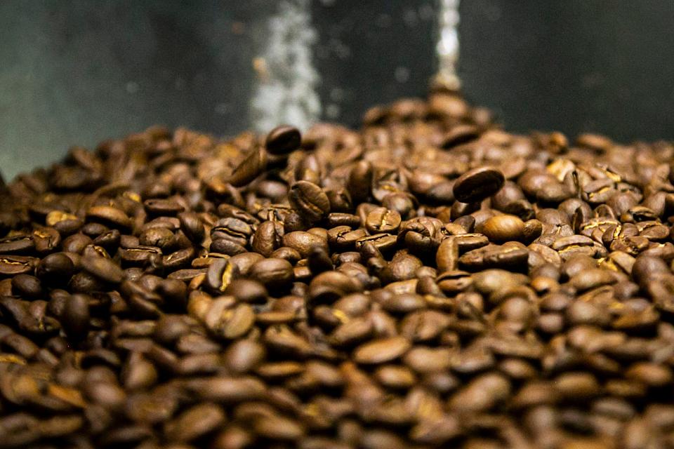 Coffee beans are placed in a hopper after being roasted at Cafe del Sol, Thursday, Jan. 20, 2022, in Iowa City, Iowa.