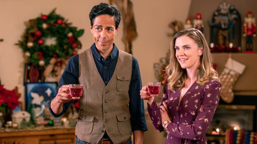 The Christmas Yule Blog -- Lifetime TV Movie (L to R) Zak Santiago as Oscar and Sara Canning as Caroline in The Christmas Yule Blog premiering Friday, November 6 at 8pm ET/PT. Photo by Courtesy of Lifetime Copyright 2020 Zak Santiago as Oscar and Sara Canning in "The Christmas Yule Blog" on Lifetime.