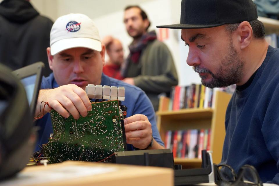 A volunteer repairs a circuit board in Malmo, Sweden, at a fortnightly repair café as part of an international grassroot network calling for the right to repair. (AP Photo/James Brooks)