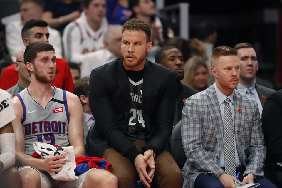 Detroit Pistons forward Blake Griffin, wearing a jersey in tribute to Kobe Bryant sits with guard Sviatoslav Mykhailiuk (19) and assistant coach Sean Sweeney during the first half of an NBA basketball game against the Cleveland Cavaliers, Monday, Jan. 27, 2020, in Detroit. (AP Photo/Carlos Osorio)