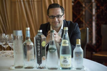 German water sommelier Martin Riese poses for a portrait by bottles of water to be used in a water tasting class at Patina restaurant in Los Angeles, California February 25, 2015. REUTERS/Mario Anzuoni