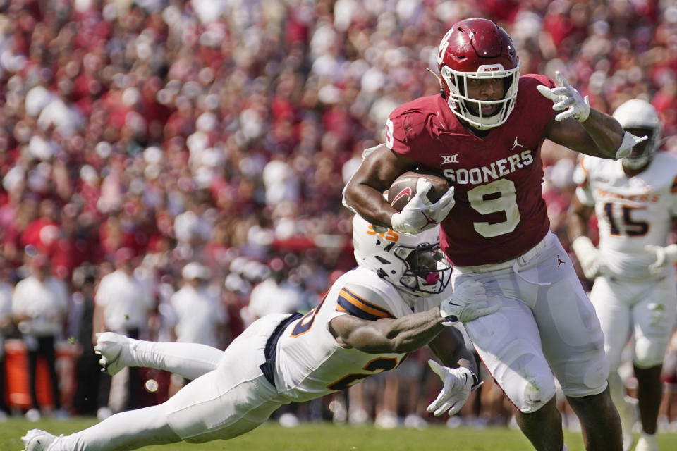 Oklahoma tight end Brayden Willis (9) avoids a tackle by UTEP defensive back Darius Baptist, left, and takes a Dillon Gabriel pass into the end zone for a touchdown in the first half of an NCAA college football game, Saturday, Sept. 3, 2022, in Norman, Okla. (AP Photo/Sue Ogrocki)