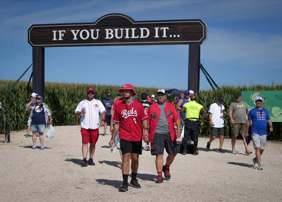 Cincinnati Reds fans walk the grounds of the Field of Dreams prior to the start of Thursday's Major League Baseball game between the Reds and the Chicago Cubs in Dyersville.