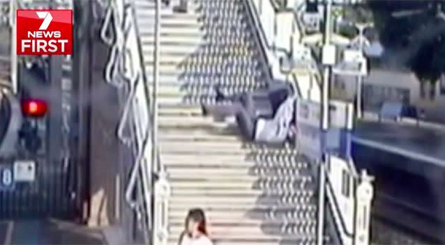 A man rushing to catch the train falls down 25 steps. Source: 7 News