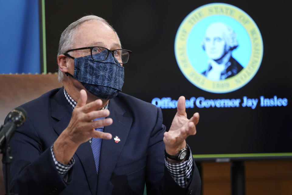 FILE - In this Dec. 17, 2020 file photo, Washington Gov. Jay Inslee talks to reporters at the Capitol in Olympia, Wash. State lawmakers across the country will be convening in 2021 with the continuing COVID-19 pandemic rippling through much of their work — and even affecting the way they work. After 10 months of emergency orders and restrictions from governors and local executive officials, some state lawmakers are eager to reassert their power over statewide decisions shaping the way people shop, work, worship and attend school (AP Photo/Ted S. Warren, File)