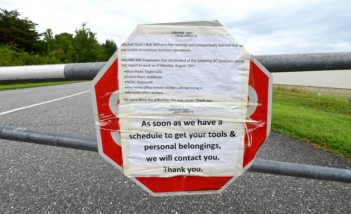 Hundreds of furniture company workers lost their jobs after the Mitchell Gold + Bob Williams furniture company closed abruptly in Augus 2023. This was a sign posted on the gate at the Taylorsville, plant.