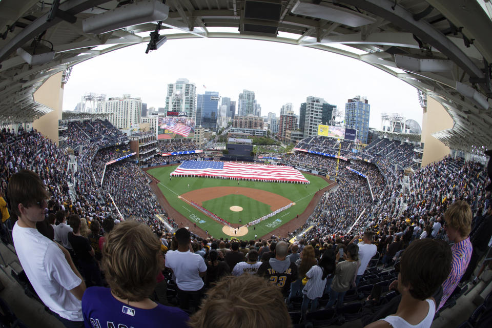 A giant United States flag is displayed during the national anthem prior to a baseball game between the San Diego Padres and the Cincinnati Reds, Thursday, June 17, 2021, in San Diego. (AP Photo/Derrick Tuskan)