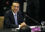 Chinese Premier Li Keqiang smiles as he glances at ASEAN leaders after delivering his statement at the ASEAN Plus China Summit in the ongoing 33rd ASEAN Summit and Related Summits Wednesday, Nov. 14, 2018 in Singapore. China's premier sought Tuesday to reassure its neighbors that Beijing will push ahead with reforms needed to support growth across the region and also keep the peace in contested waters in the South China Sea. (AP Photo/Bullit Marquez)