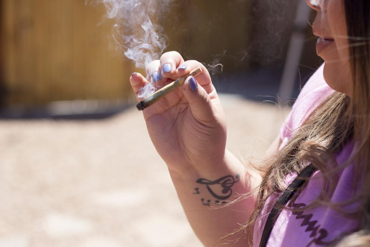 Consumers smoke cannabis at Sol Cannabis on East Idaho Avenue on April 20, 2022.