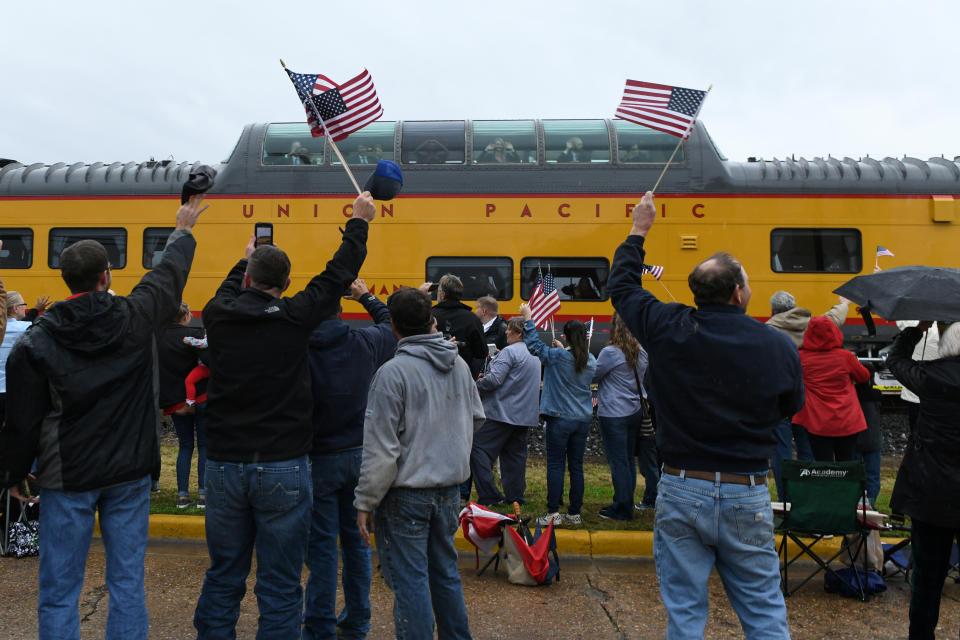 Spectators cheer and wave flags as the Union Pacific funeral train carrying the casket of former President George H.W. Bush passes through Navasota, Texas, Dec. 6, 2018. (Photo: Nick Oxford/Reuters)
