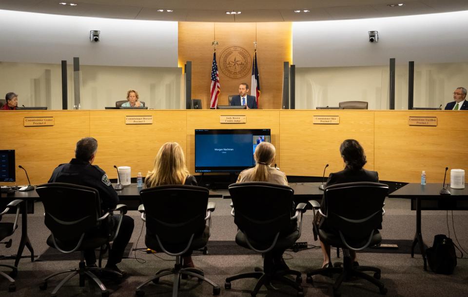 Travis County Commissioners Gomez, left, Howard and Travillion, right, along with Travis County Judge Andy Brown, center, listen to comment from officials, including Austin Police Chief Joseph Chacon, lower left, ahead of their vote to begin the development of a new mental and behavioral diversion center in an effort to divert people who are experiencing a mental health episode away from jail at the Travis County Administration building, March 21, 2023. 