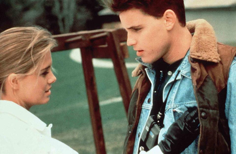 <p>United Archives GmbH/Alamy Stock Photo</p> Nicole Eggert and Corey Haim on set of Blown Away in 1993.