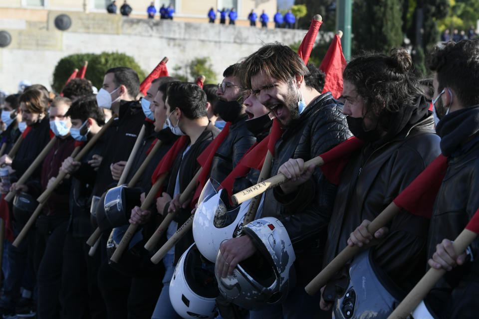 Protesters shout slogans during a rally in Athens, Greece, on Monday Dec. 6, 2021. Hundreds of protesters marched the streets of the Greek capital, on the 13th anniversary of the 15-year old Alexis Grigoropoulos' fatal shooting by the police. (AP Photo/Michael Varaklas)