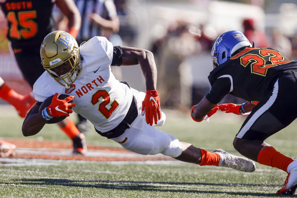 North running back Joshua Kelley of UCLA (2) dives for extra yardage as South defensive back Reggie Robinson II of Tulsa (22) defends during the first half of the Senior Bowl college football game Saturday, Jan. 25, 2020, in Mobile, Ala. (AP Photo/Butch Dill)