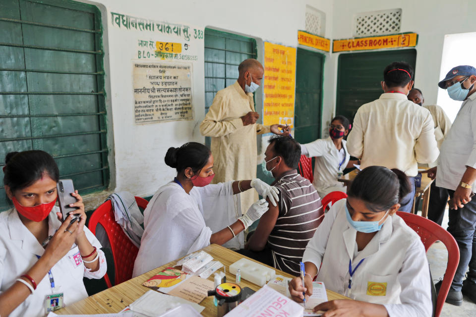 A vaccination drive against COVID-19 is in progress at a government school in Amritpur village, Uttar Pradesh state, India, on June 10, 2021. India's vaccination efforts are being undermined by widespread hesitancy and fear of the jabs, fueled by misinformation and mistrust. That's especially true in rural India, where two-thirds of the country’s nearly 1.4 billion people live. (AP Photo/Rajesh Kumar Singh)