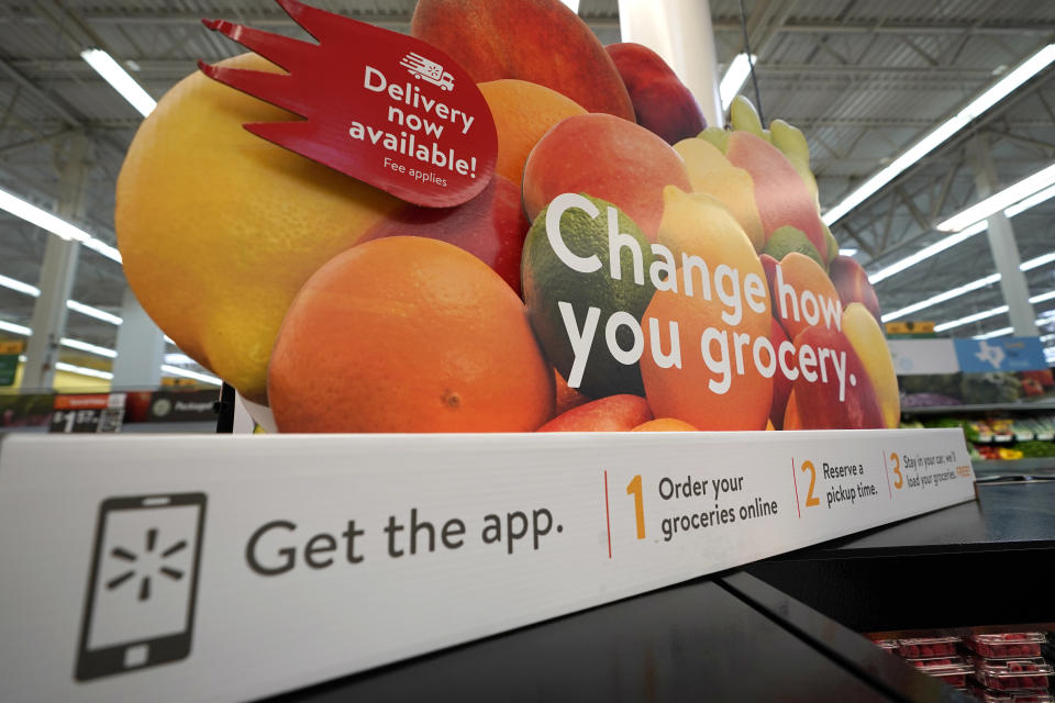 A sign promotes online and home delivery of groceries at a Walmart Supercenter Friday, Nov. 9, 2018, in Houston. (AP Photo/David J. Phillip)