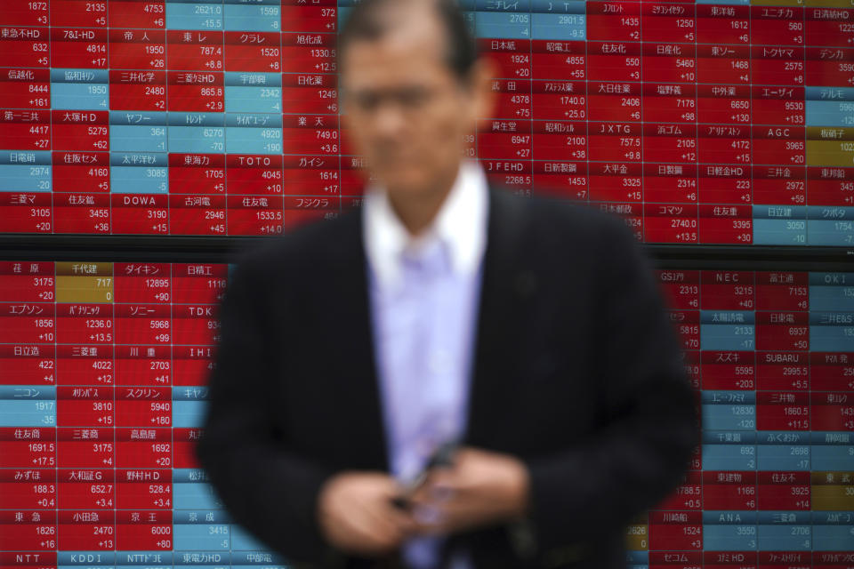 A man walks past an electronic stock board showing Japan's Nikkei 225 index at a securities firm in Tokyo Friday, Oct. 26, 2018. Asian shares were mostly higher Friday, cheered by a jump on Wall Street as strong earnings reports from market bellwethers like Microsoft and Comcast gave a confidence boost to investors shaken by the recent wave of selling.(AP Photo/Eugene Hoshiko)