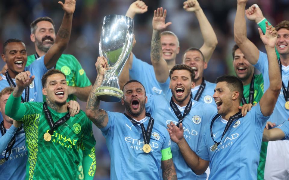 Kyle Walker of Manchester City lifts the UEFA Super Cup trophy after the team's victory in the UEFA Super Cup 2023 match