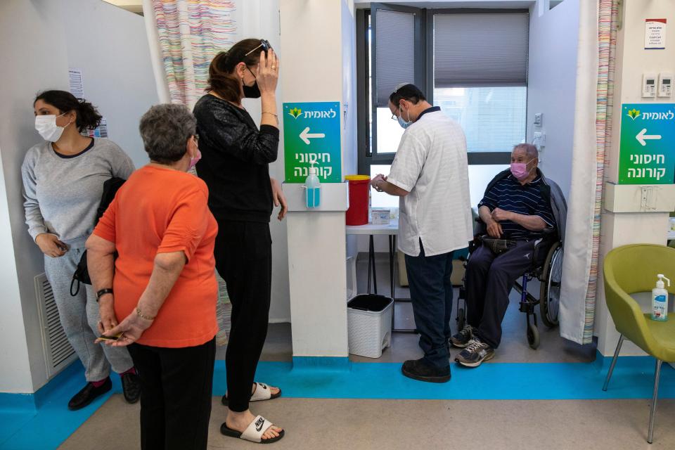 People await vaccination at a centre in Israel, where there has been a surge in casesAP