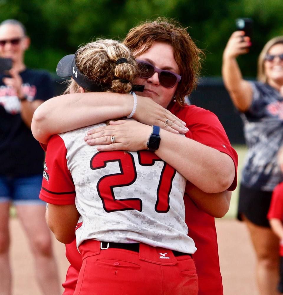 Paula and Olivia Dumm embrace each other following a Lady Mustangs' tournament win.
