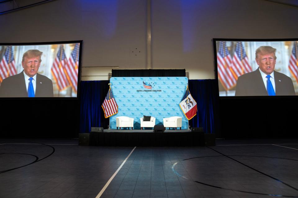 A recorded video of former President Donald Trump plays for the audience at the Iowa Faith & Freedom Coalition's annual spring kickoff, on Saturday, April 22, 2023, in Clive, Iowa.