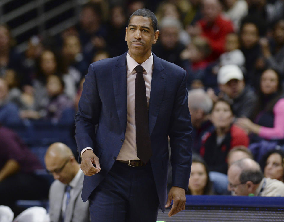 FILE - In this Feb. 25, 2018, file photo, then-Connecticut coach Kevin Ollie watches during the first half the team's NCAA college basketball game in Storrs, Conn. Former Connecticut head coach Kevin Ollie has been brought on board in a leadership role for a new basketball league designed to offer elite high school players another pathway to the pros. Ollie will serve as coach and director of player development for Overtime Elite, which markets itself to 16-to-18 year old players with guarantees of academic education and a six-figure salary. (AP Photo/Jessica Hill, File)